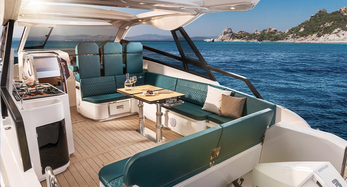 Open kitchen area of the Vida 33 on the water with the coast in the background.