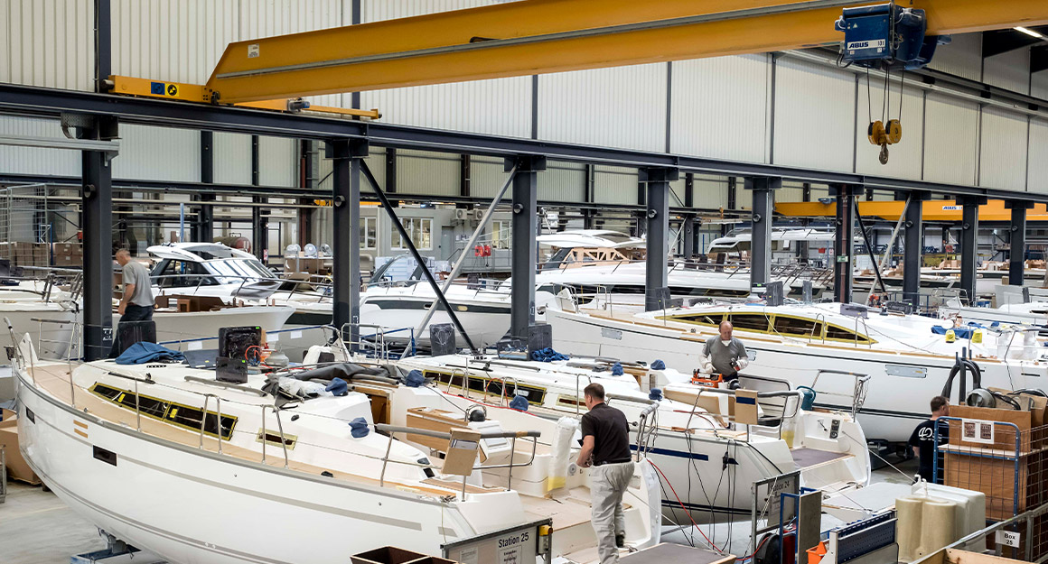 Full shipyard with numerous boats and workers.
