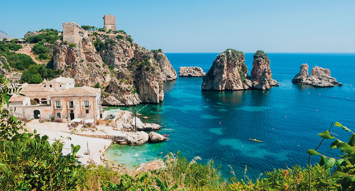 View of the deep blue Mediterranean bay of Tonnara Scopello with cliffs.