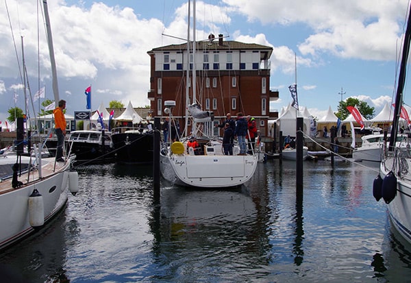 Marina with many sailing yachts and people.