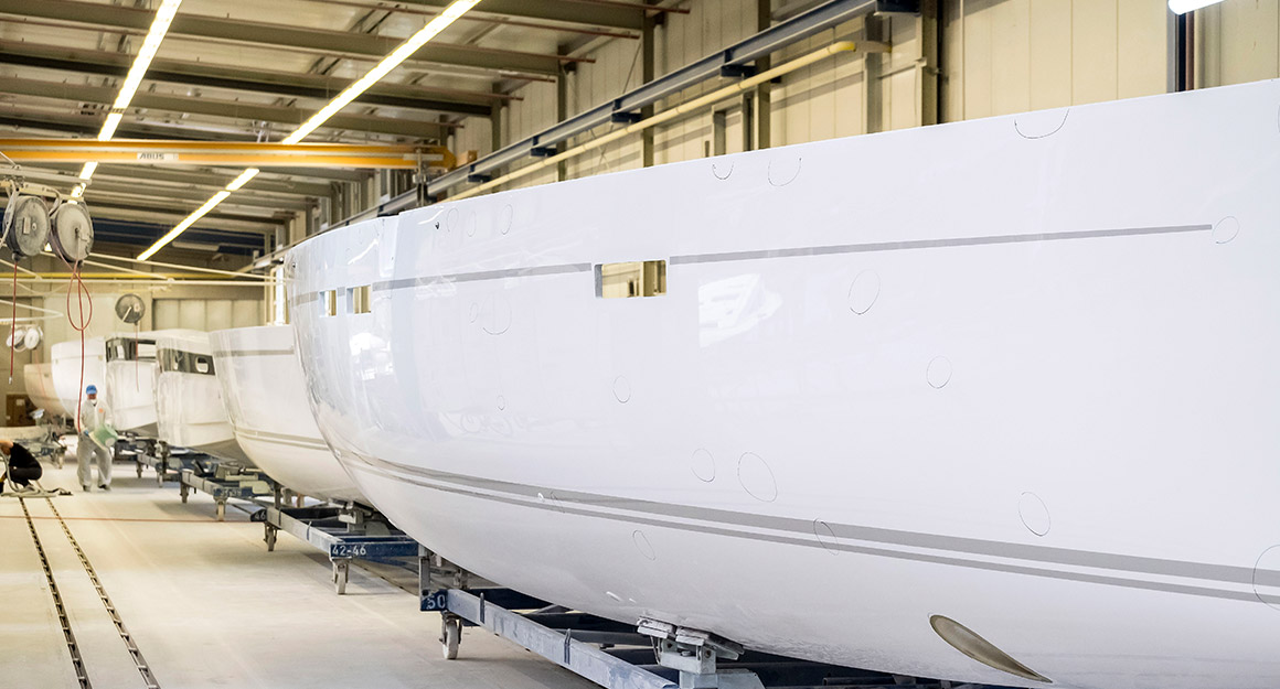 Several boat hulls in a row in the shipyard.