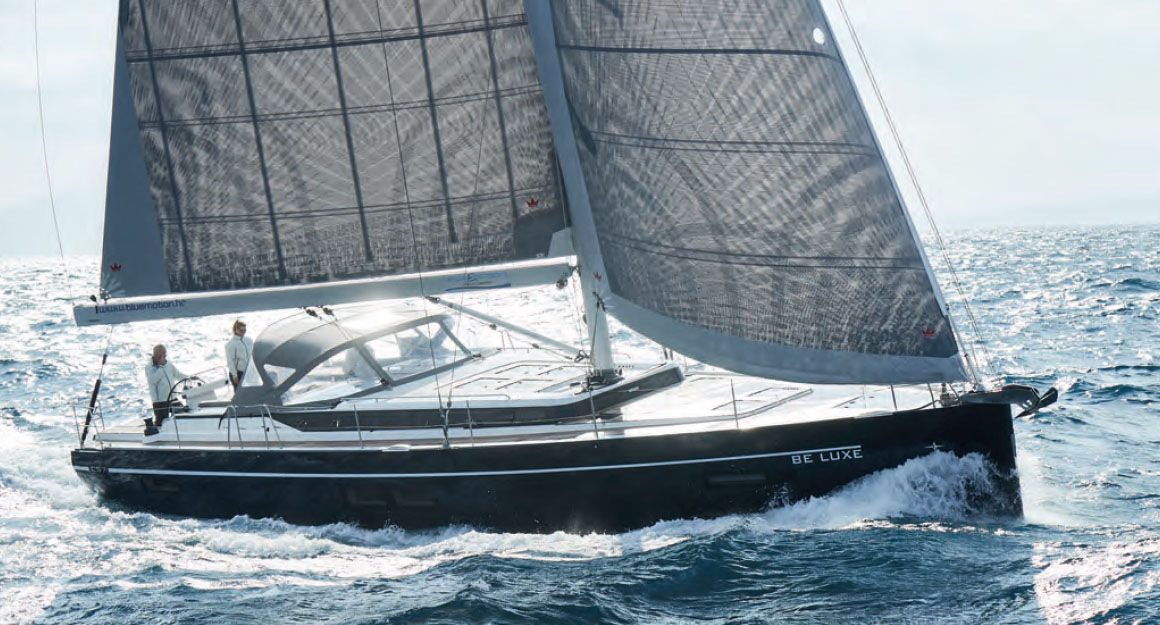 Sailing yacht from the side on the sunlit water.