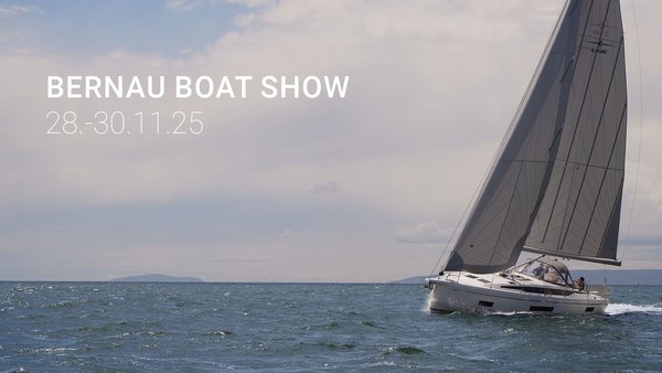 Weißes Segelboot mit grauen Segeln auf dem Meer. Bewölkter Himmel. Schriftzug "Bernau Boat Show"